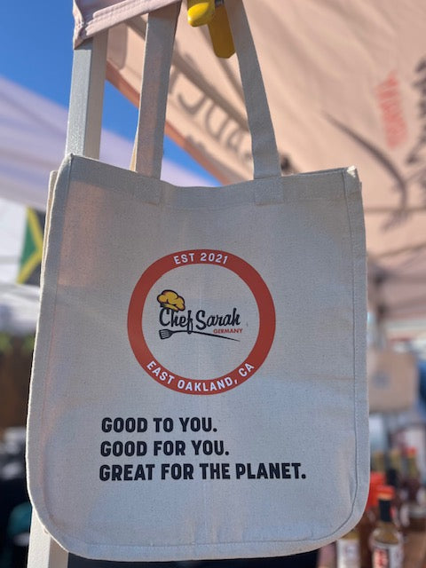 Tote bag with 'Chef Sarah' logo and text, hanging outdoors.